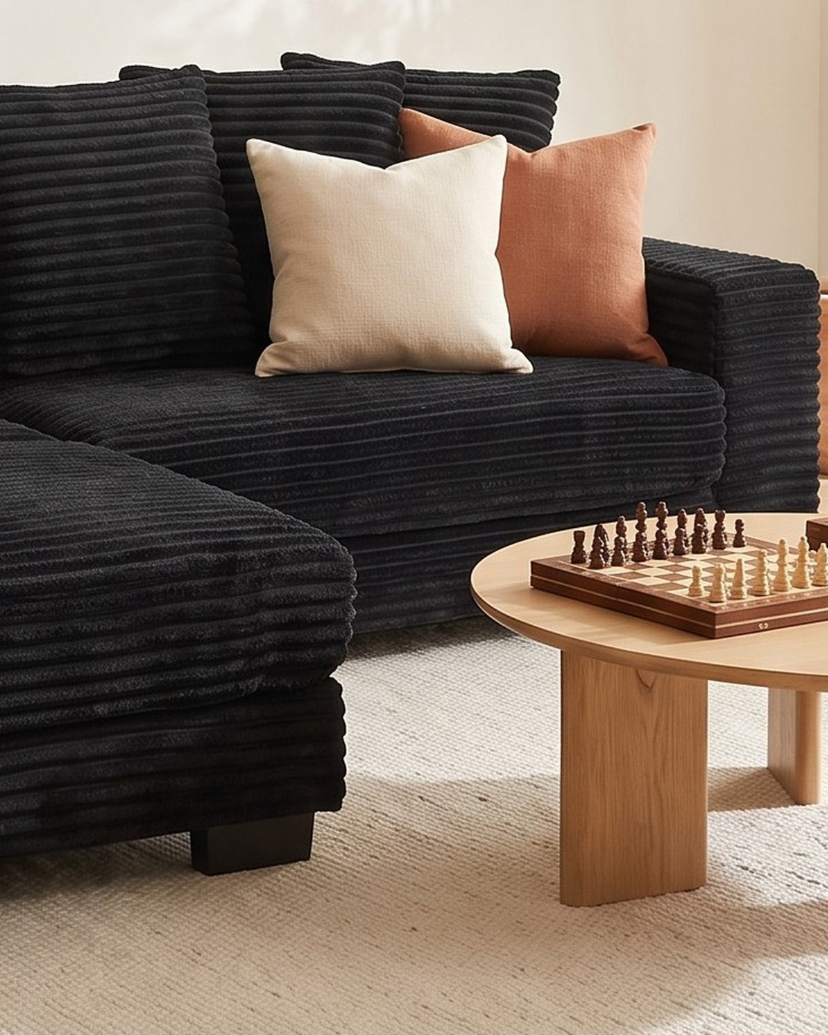 Black Corduroy L-Shaped Sectional with Reversible Chaise, 111 in in Black, chaise shown on the left (reversible), close-up of the right end