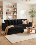 Black Corduroy L-Shaped Sectional with Reversible Chaise, 111 in in Black, chaise shown on the left (reversible), styled in a bright living room [c:black] [r:good]
