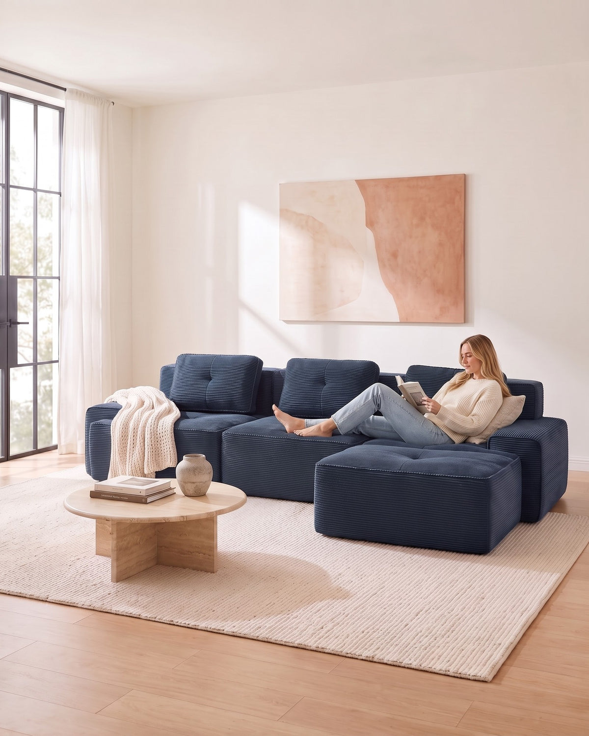 Blue Tufted Corduroy Sectional with Ottoman, 117 in in Blue, with a person relaxing on it