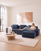 Blue Tufted Corduroy Sectional with Ottoman, 117 in in Blue, with a person relaxing on it [c:blue] [r:comfort]