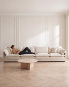 Chenille Modular 4-Seat Sofa in Beige, with a person relaxing on it [c:beige] [r:comfort]