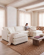 Chenille U-Shaped Sectional with 2 Reversible Ottomans, 3 Seats in White, with a person relaxing on it [c:white] [r:comfort]