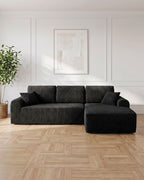 Cloud Modular L-Shaped Sectional with Chaise, 109 in in Black, chaise on the left, styled in a bright living room [c:black] [r:good]