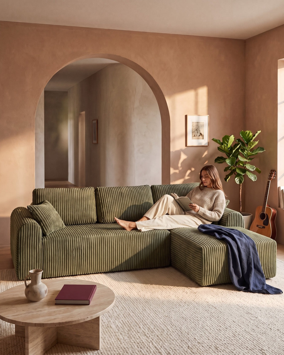 Cloud Modular L-Shaped Sectional with Chaise, 109 in in Green, chaise on the right, with a person relaxing on it