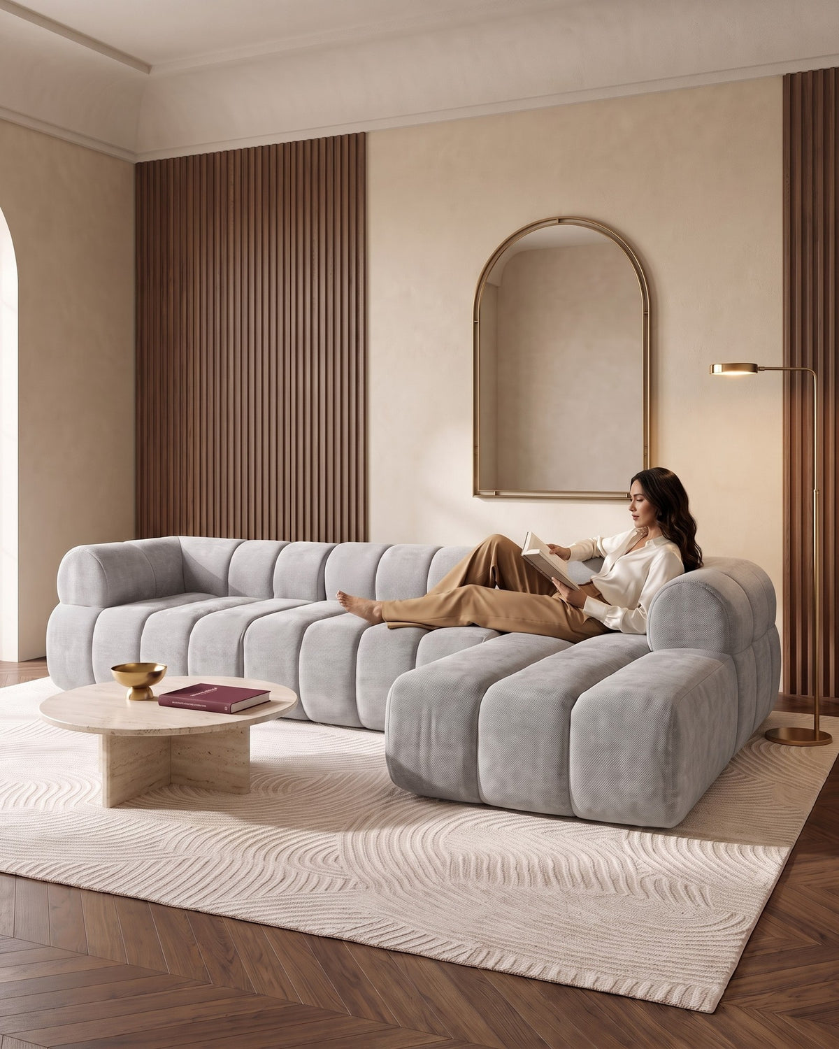 Compressed L-Shaped Sectional with Chaise, 122 in in Grey, with a person relaxing on it