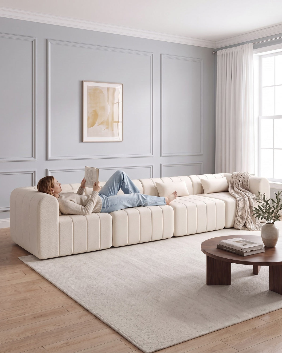 Compressed Modular Sectional, 145 in in Beige, with a person relaxing on it