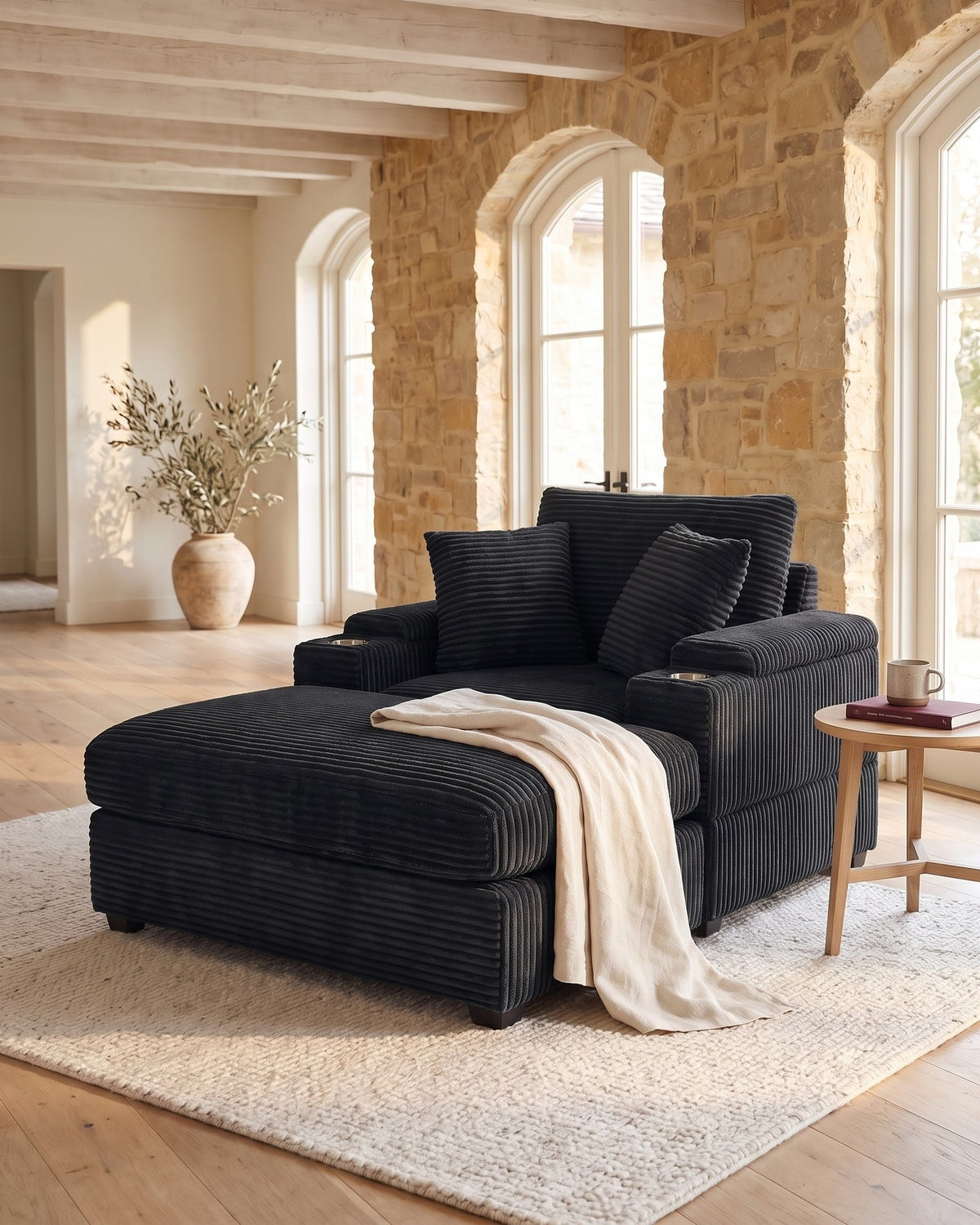 Corduroy Chair and a Half with Storage Arms and Ottoman in Black, styled in a bright living room