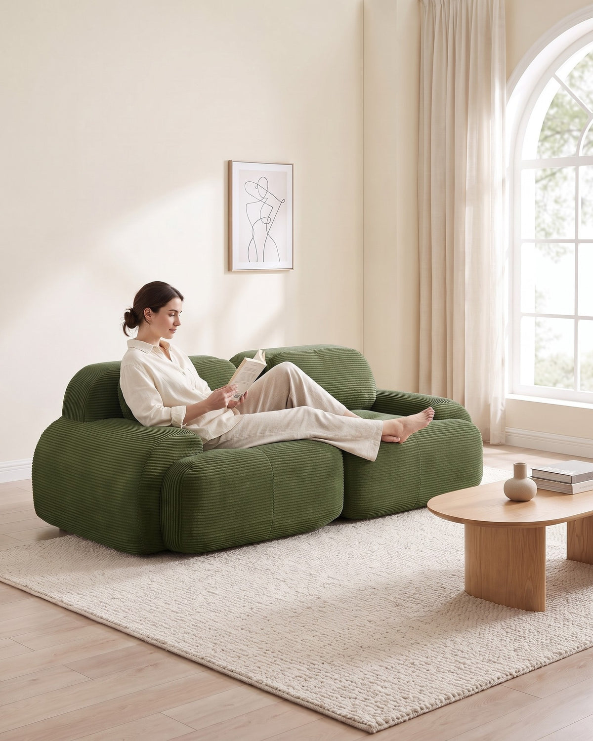 Corduroy Modular Loveseat, 82 in in Olive Green, with a person relaxing on it