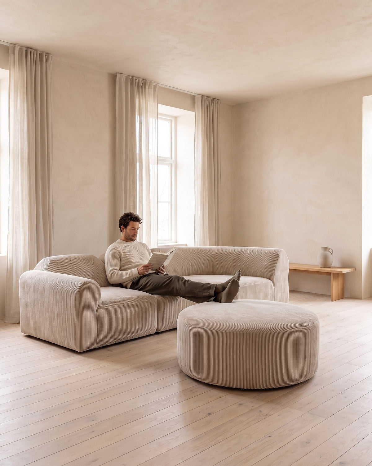 Curved Deep-Seat Sectional with Ottoman, 111 in in Espresso, with a person relaxing on it