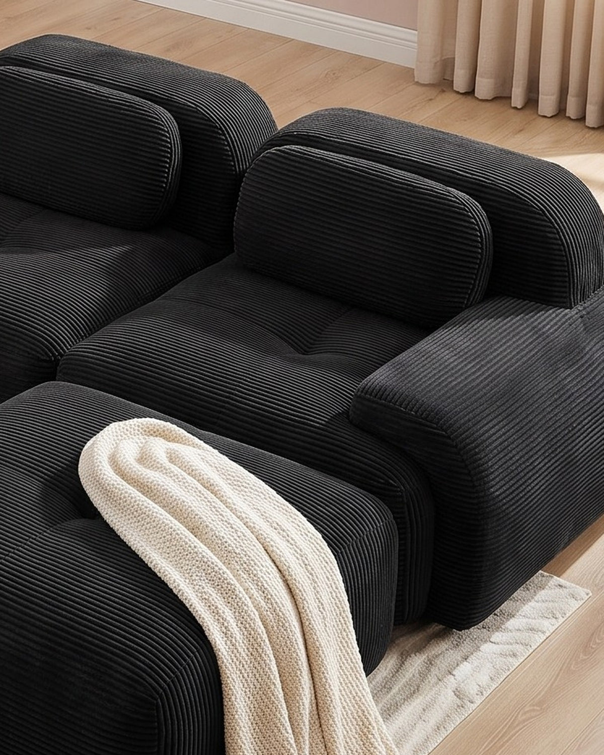 Modular Sofa with Reversible Ottoman, 4 Seats in Black, close-up of the right end