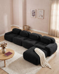Modular Sofa with Reversible Ottoman, 4 Seats in Black, styled in a bright living room [c:black] [r:good]