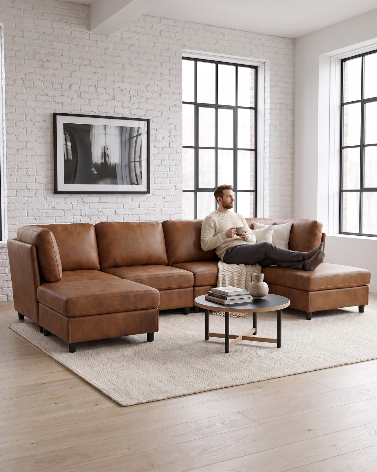 Modular U-Shaped Sectional with Two Ottomans, 6 Pieces in Light Brown, with a person relaxing on it