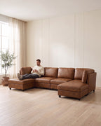 Modular U-Shaped Sectional with Two Ottomans, 6 Pieces in Light Brown, with a person relaxing on it [c:lightbrown] [r:comfort]