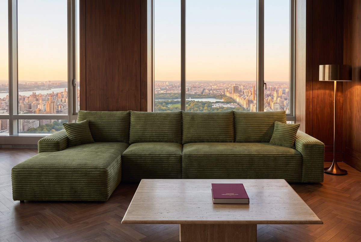 Green corduroy L-shaped sectional facing a city view at sunset