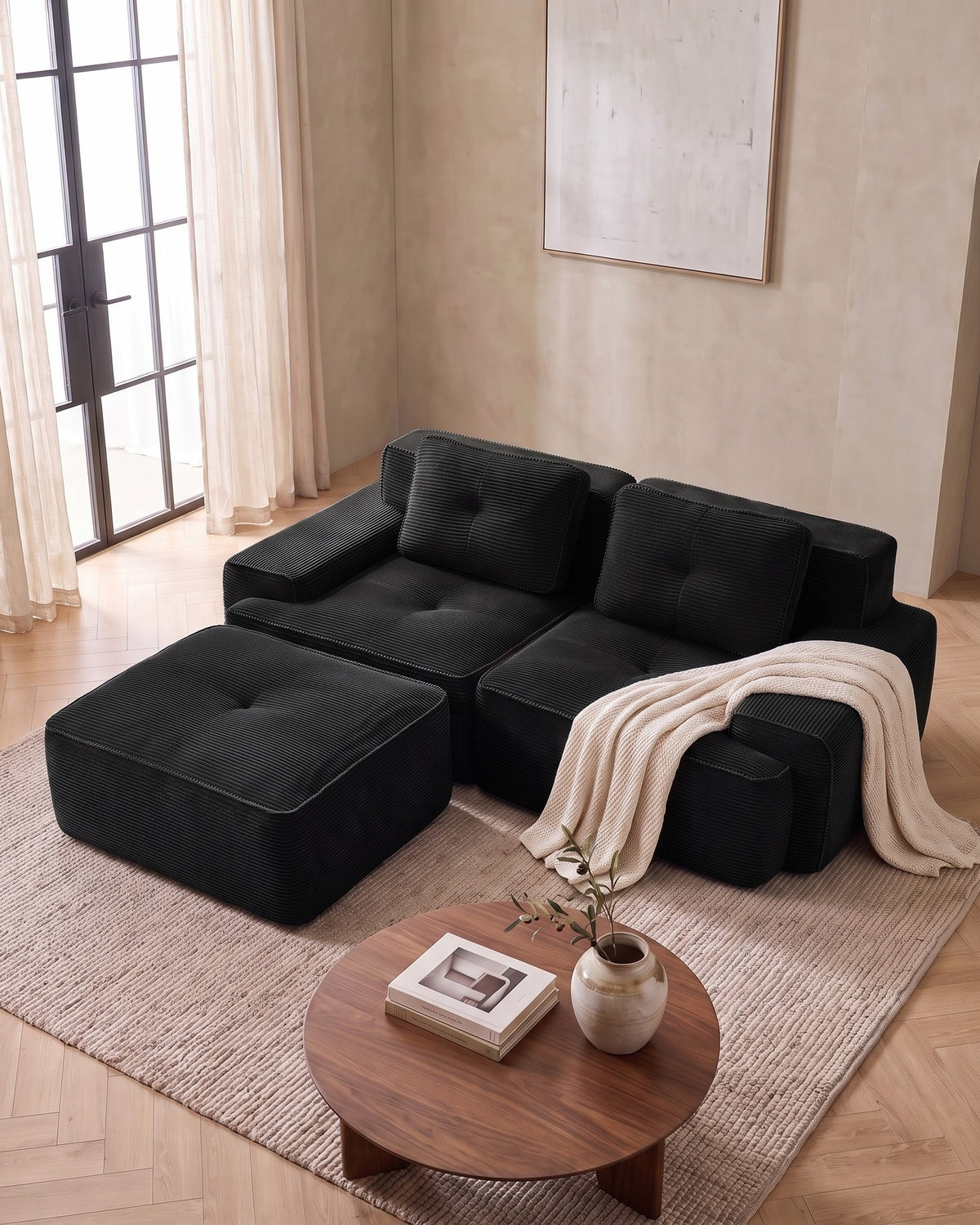 Tufted Corduroy Modular Loveseat with Ottoman in Black, styled in a bright living room