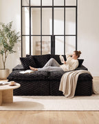 Velvet Double Chaise Lounge Sofa, 72 in in Black, with a person relaxing on it [c:black] [r:comfort]