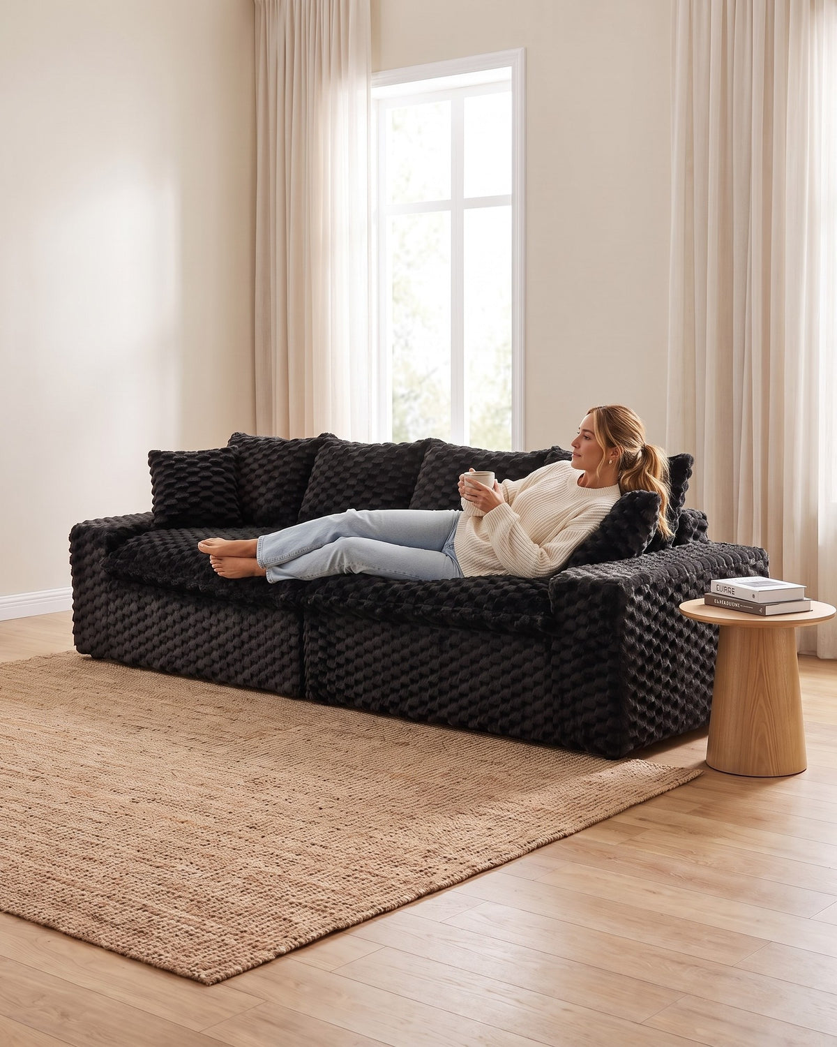 Velvet Modular Sofa, 4 Seats, 120 in in Black, with a person relaxing on it